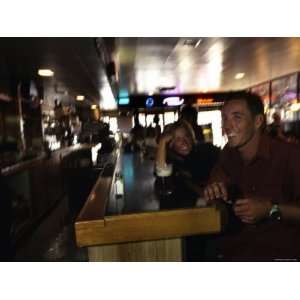  Man and a Woman Share a Beer and a Laugh at a Bar, Utah 