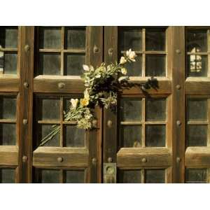  Flowers on the Wooden Door of a Mausoleum in a Cemetery 