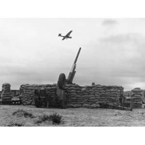 Plane Passing over Anti Aircraft Gun Position Protected by Sandbags 