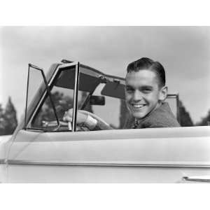  Man Smiling at Camera, Sitting at Steering Wheel of Convertible Car 